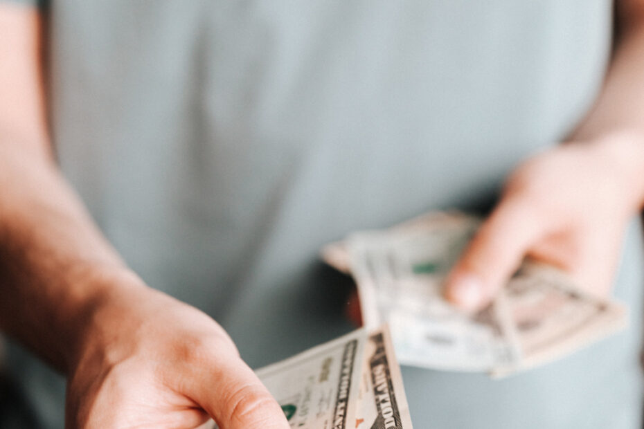 Free Crop man paying with American dollars Stock Photo