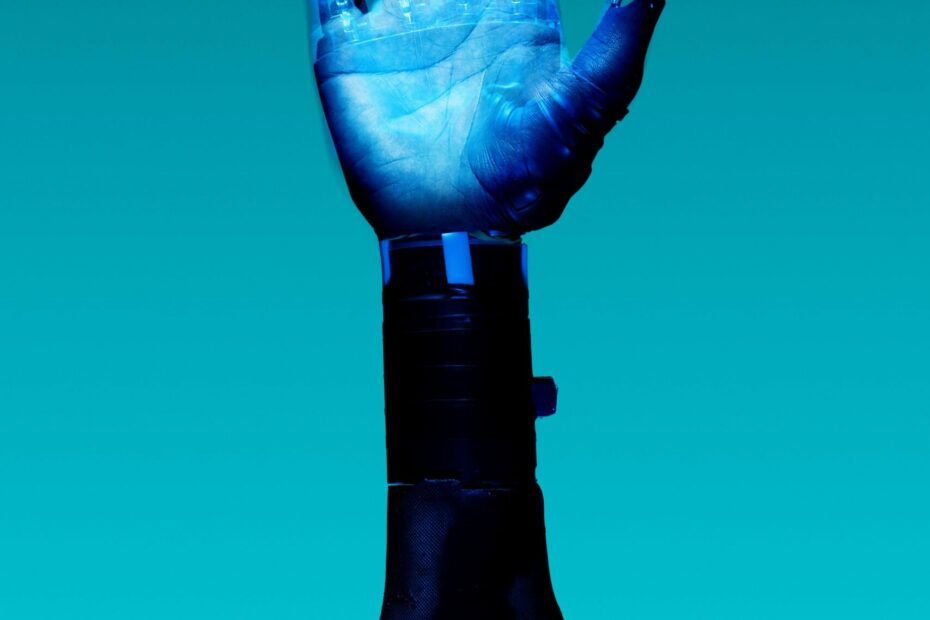 alt="Free Prosthetic Arm on Blue Background Stock Photo"